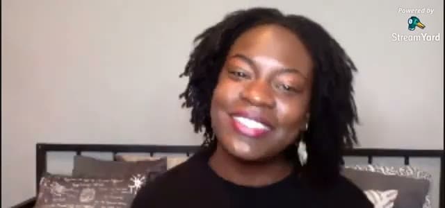 Raven Baxter, with shoulder-length locs and drop earrings, laughs on camera in a livestream frame marked Powered by StreamYard.