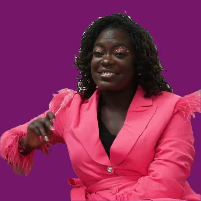 Dr. Raven Baxter in a pink suit, talking with her hands