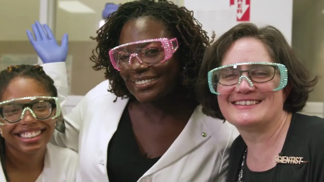 Dr. Raven Baxter in pink goggles taking a selfie with Sydney Anderson and Dr. Sarah Bowman in the lab, from Nerdy Jobs Episode 1