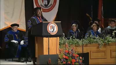 Dr. Raven Baxter delivering a commencement address