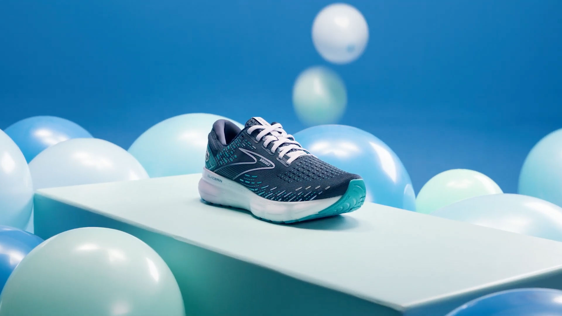 A Brooks Glycerin running shoe surrounded by floating nitrogen bubbles