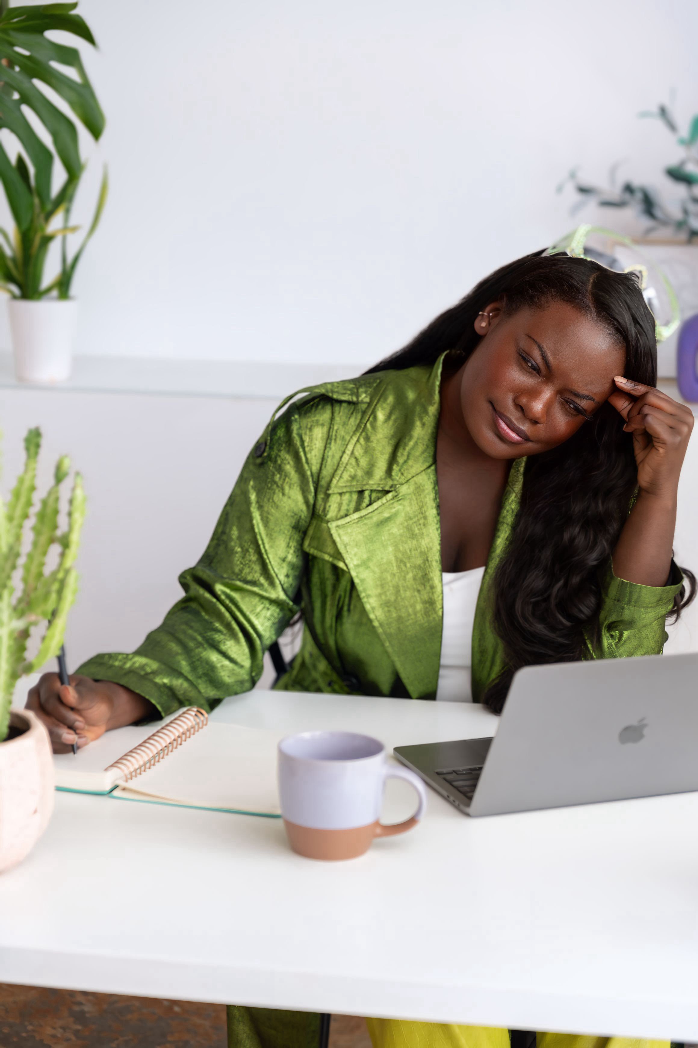 Dr. Raven Baxter writing at her desk
