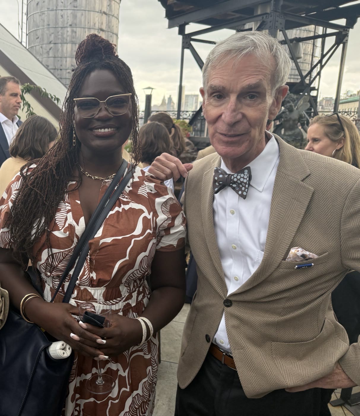 Dr. Raven Baxter with Bill Nye at an evening event on a New York rooftop